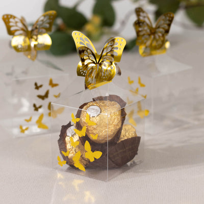 Transparent gift box with gold butterfly accents and chocolate truffles inside.