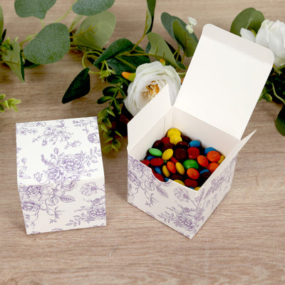 Decorative gift box filled with colorful candies on wooden surface.