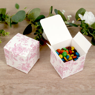 Decorative gift box with colorful candies inside, floral pattern design.