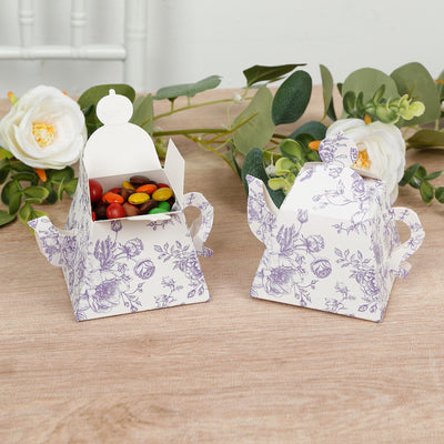 Decorative teapot-shaped candy boxes with floral design.