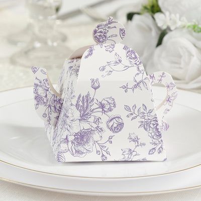 Purple floral tea box on a white plate.