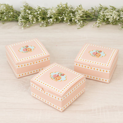 Pink floral storage boxes with decorative designs.