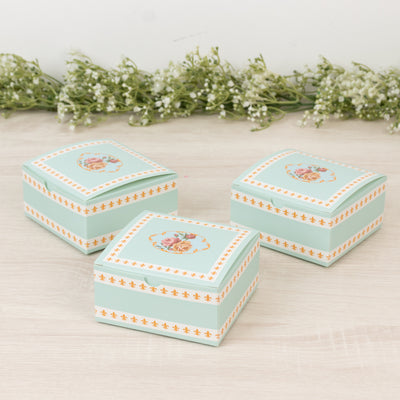 Decorative floral storage boxes in mint green and white, set of three.