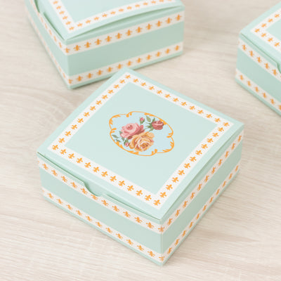 Decorative floral box with mint green design and orange accents