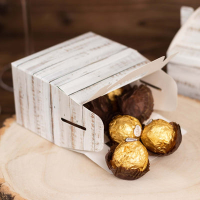 Chocolate truffles in a rustic takeout box on a wooden surface.