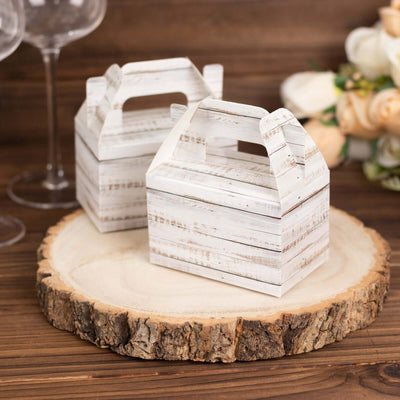 Rustic wooden gift boxes on a wooden slice with floral decor.