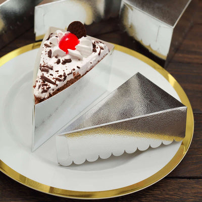 Chocolate cake slice in a silver cake box on a decorative plate.