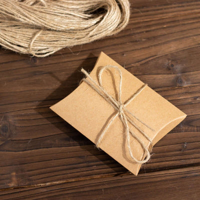 Brown gift box tied with twine on a wooden surface.