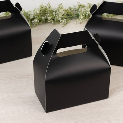 Black gift box with handle on a plain background.