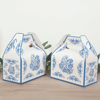 Blue floral takeout boxes on a wooden surface.