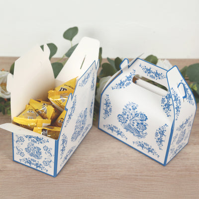 Decorative takeaway boxes filled with candies on a wooden surface.