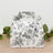 Floral patterned gift box with a handle on a wooden surface.
