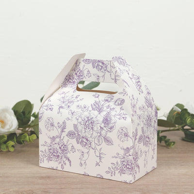Decorative floral gift box with handle on wooden surface.