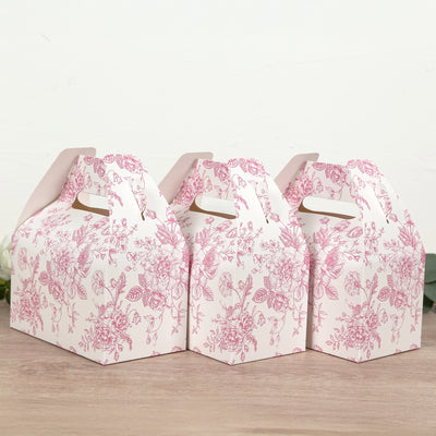 Set of three floral-patterned takeout boxes on a wooden surface.