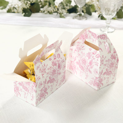 Floral-patterned takeout boxes with snacks inside on a light table setting.