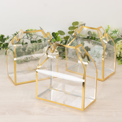 Clear acrylic gift boxes with gold trim, perfect for special occasions.