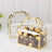 Clear treat boxes with gold trim filled with assorted chocolates.
