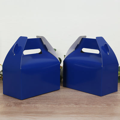Blue gift boxes with handles on a wooden surface.