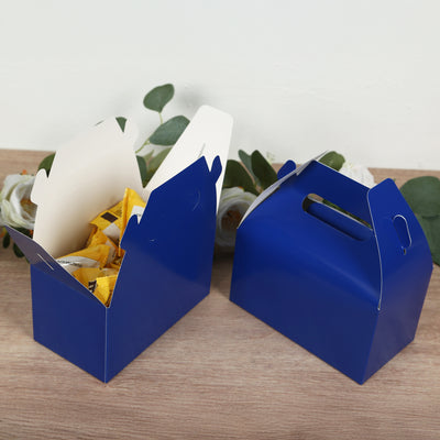 Blue gable boxes filled with snacks on a wooden surface.