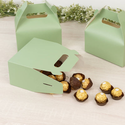 Green takeaway boxes with gold chocolate truffles spilling out.