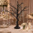 Black tree wedding centerpiece with crystal garlands and candlelit table decor