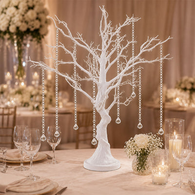 Elegant white tree centerpiece with hanging crystals at a wedding reception table