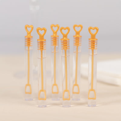 Set of six heart-shaped bubble wands in clear tubes.