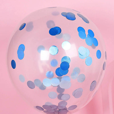 Clear balloon filled with blue confetti on a pink background.