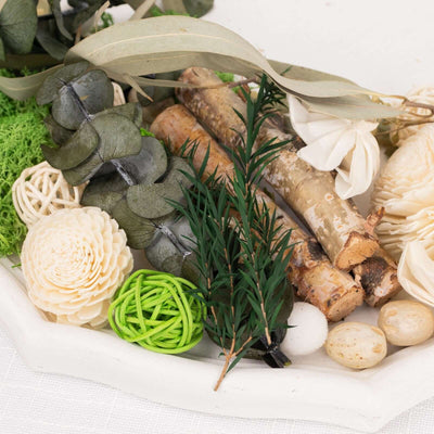 Natural decorative elements including branches, flowers, and moss in a tray.