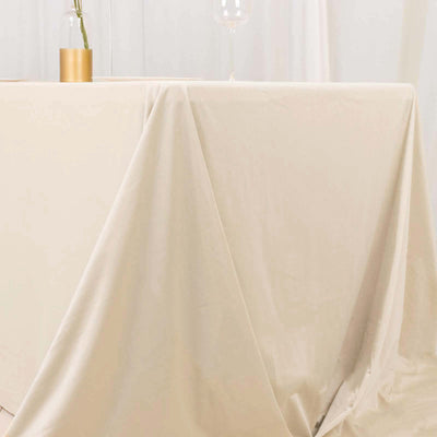 Beige tablecloth draped over a table in a minimalist setup.