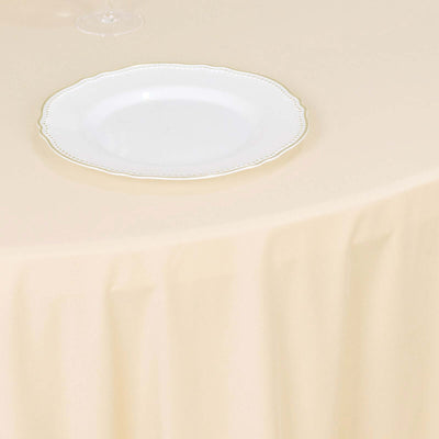 Elegant white plate on a cream tablecloth.