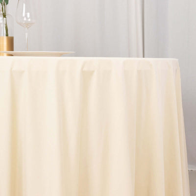 Cream tablecloth draped elegantly over a table in a minimalist setting.