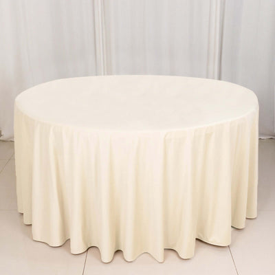 Round cream tablecloth draping elegantly over a round table.