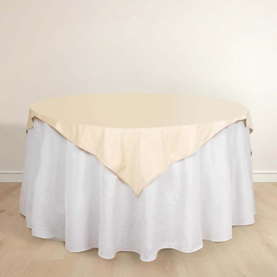 Round table with cream-colored tablecloth and white skirt