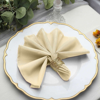 Elegant beige napkin folded on a decorative plate.