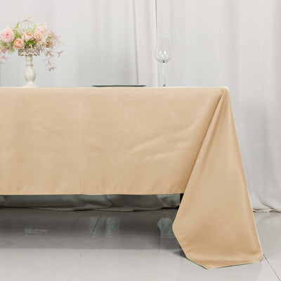 Beige tablecloth draping elegantly over a table with decorative elements.