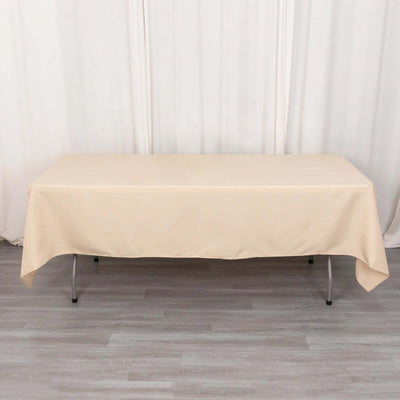 Beige tablecloth draped over a folding table in a studio setting