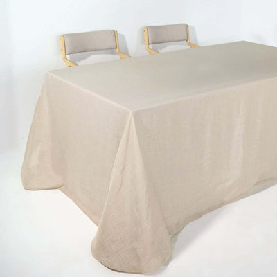 Beige tablecloth draped over a table with two wooden chairs