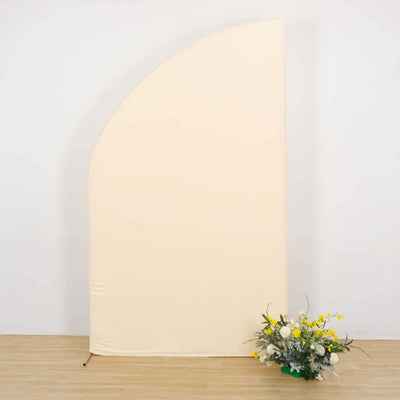 Floral arrangement in front of a soft beige backdrop.