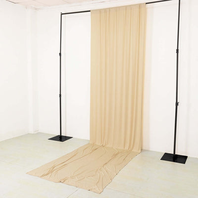 Beige photography backdrop draped on a support stand