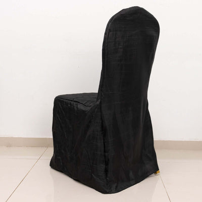 Black chair cover for event decor, showcasing sleek design and elegant draping.