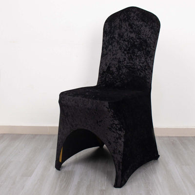 Black velvet chair cover on a plain backdrop.