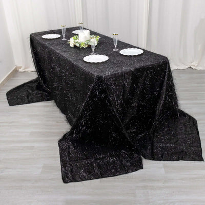 Black tablecloth draped elegantly over a long table for an event setting.