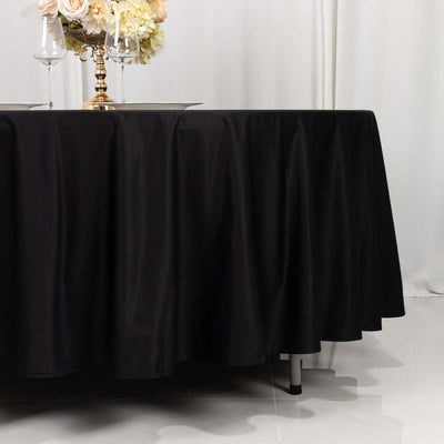 Black tablecloth draping elegantly over a table, enhancing a stylish dining setup.