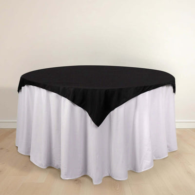 Black and white round tablecloth with elegant draping.