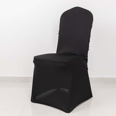 Black stretch chair cover on a plain white backdrop.