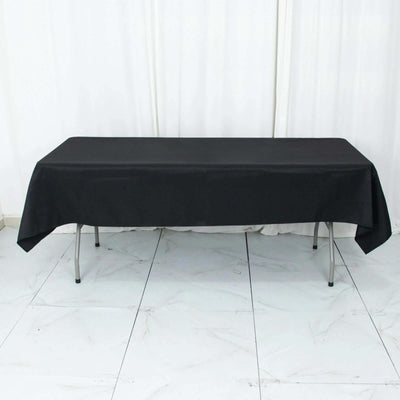 Black tablecloth draped over a table in a studio setting.