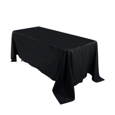 Black tablecloth draped over a rectangular table