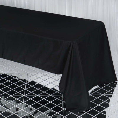 Black tablecloth draped over a table in a studio setting.