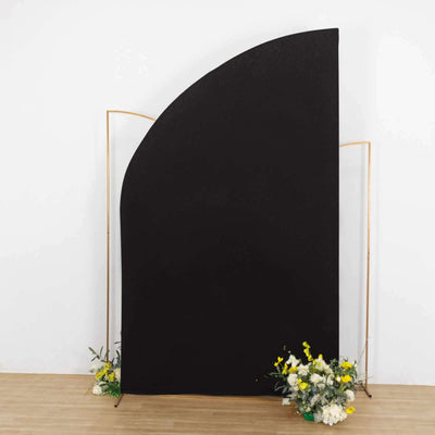 Black curved backdrop with floral arrangement at the base.